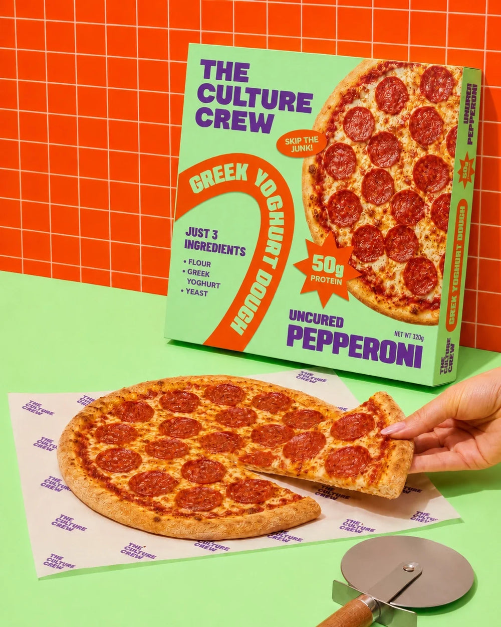 An Uncured Pepperoni pack behind the pizza, with a slice being lifted